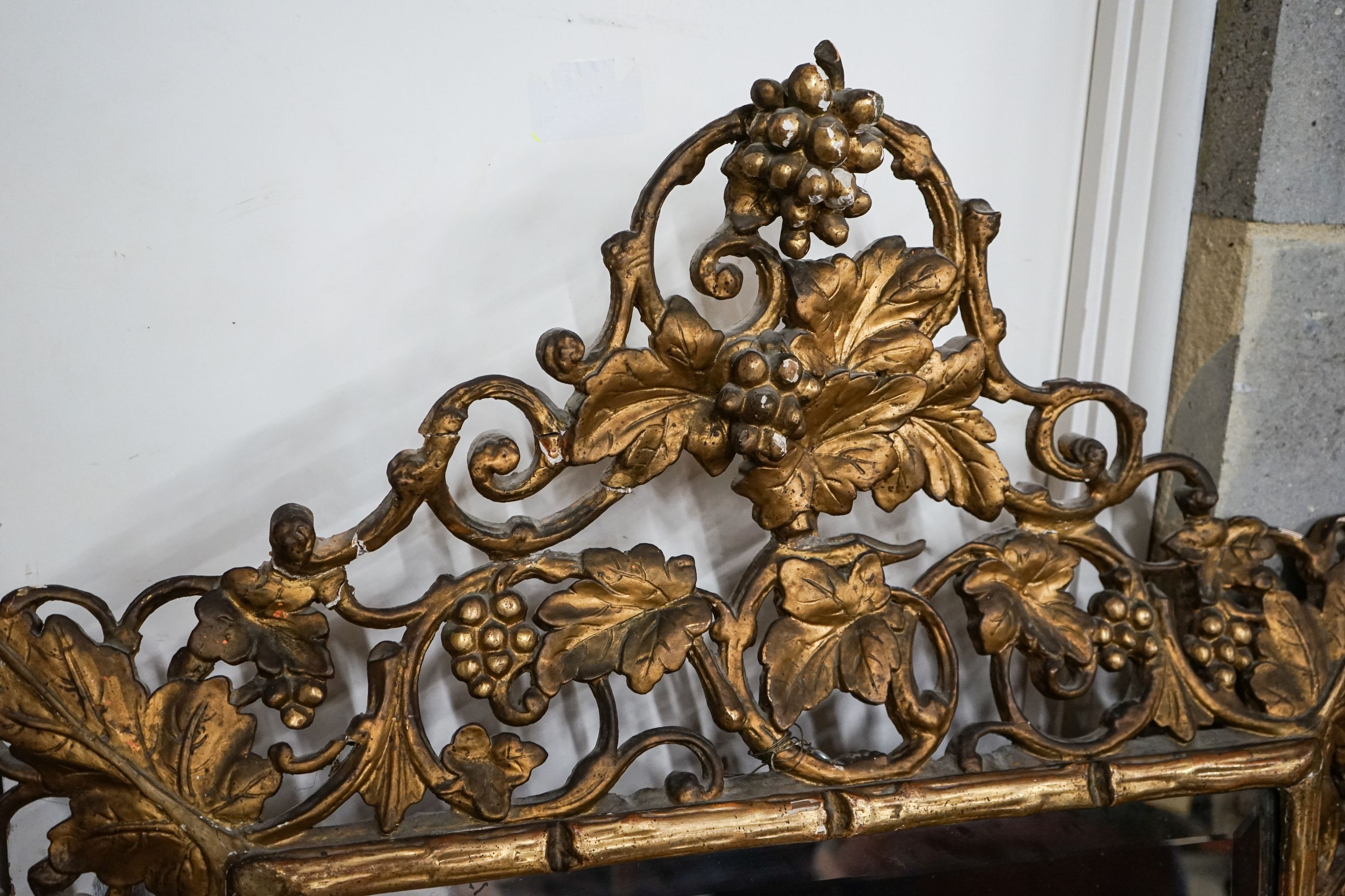 A Victorian carved giltwood and gesso rectangular wall mirror with pierced fruiting vine border, width 98cm, height 148cm